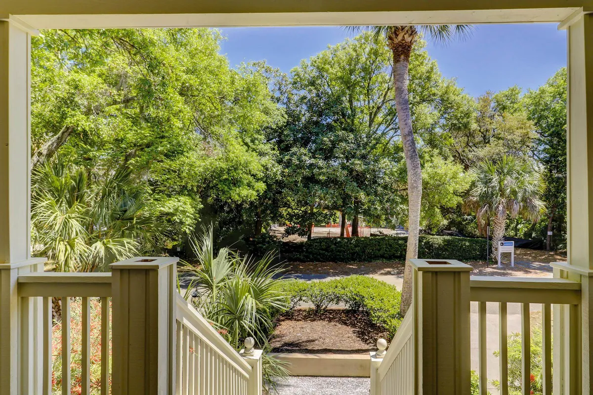 The image presents a view of steps leading down to lush greenery and palm trees, creating a seamless transition from the home to the outdoors. The inviting pathway and tropical landscaping encourage exploration and moments of peaceful solitude or group enjoyment.